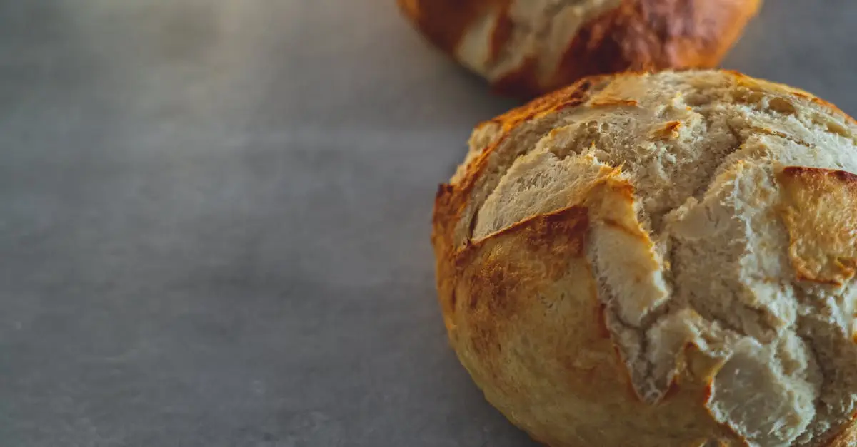 Close-up of freshly baked crusty breads on a rustic table surface, showcasing texture and craftsmanship.